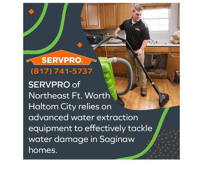 SERVPRO technician extracting water from a water damaged kitchen using industry grade equipment